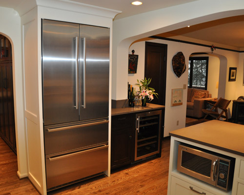 On the adjacent wall, there's the Liebherr fridge and a wine cooler/bar area.  Note the arch that divides that area