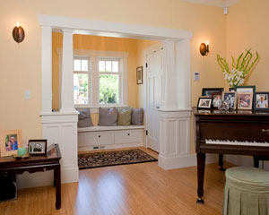Framed with tapered columns, the entry features a large coat closet and bench seating with storage