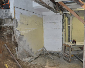 Dozens of yards of concrete were poured to create a new interior stairwell, a new, lower slab with insulation and a barrier in front of the leaking wall