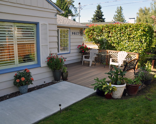 The owners also took the opportunity of the remodel to revision the entry to their home with a composite deck that mimics the look of Ipe, and re-pour the concrete entry path. This improvement also makes for a nice space to enjoy the front garden