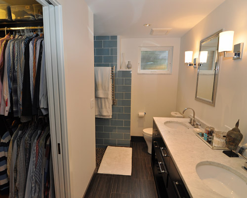 A walk-in closet is on the left, across from the vanity.  A pocket door allows it to be closed if desired.  The left wall is also the location for the thermostat for the electric floor heat