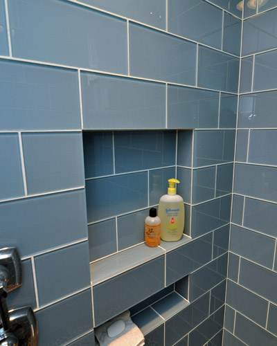 The niche next to the shower controls provides added shelf space for soap.  The niche had to be located precisely so that it would fit exactly in the vertical width of the tiles