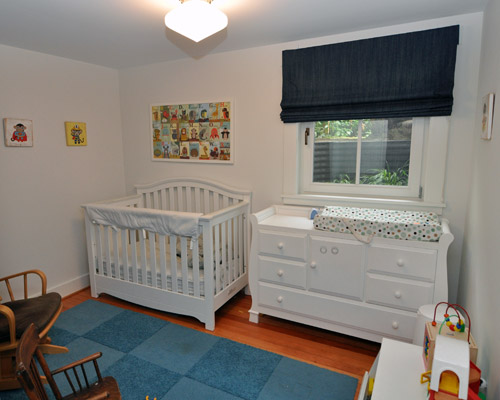 A cozy nursery with plenty of room for a rocker, and later, a twin bed and everything a child needs.  A full kids' bath is just down the hall from the bedrooms.