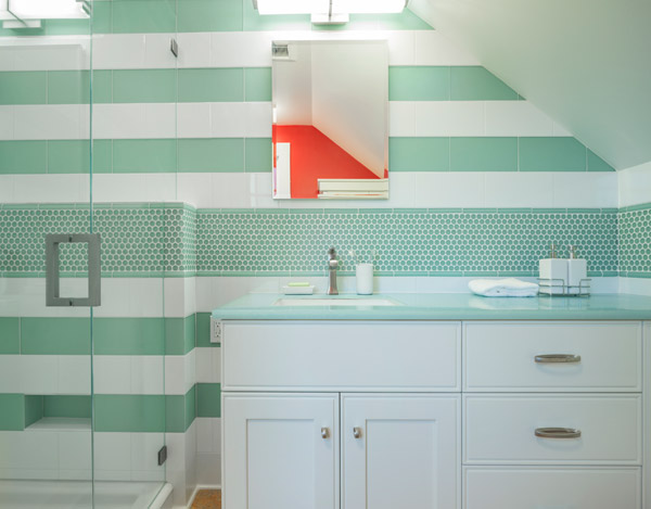 The larger bathroom has eye-popping color and tile design.  Marmoleum floors and Avonite counters again, but in different hues