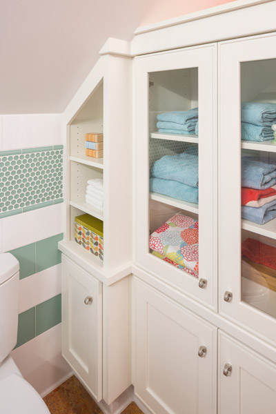 Built-ins at this bath make the most of the limited space by creating useful and accessible storage