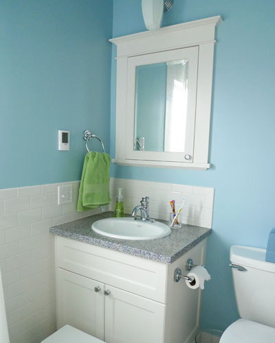 The kids bath is also remodeled.  Again, there are custom cabinets for the vanity and a medicine cabinet, but this time in a style traditional for this west Seattle bathroom remodel.   The terrazzo countertop has blue accents, picking up the color of the walls