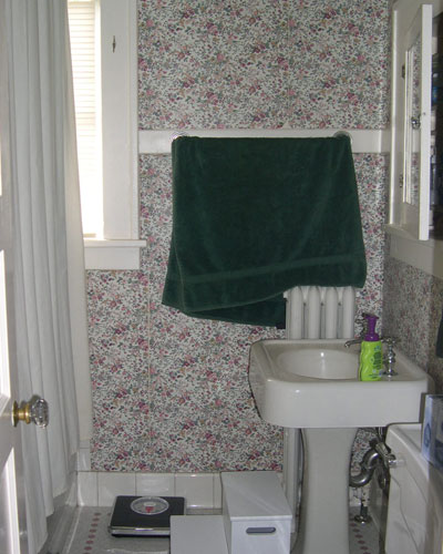 Before: Icky wallpaper, bulky radiator and a toilet nearly blocking the entrance to the kids' bath