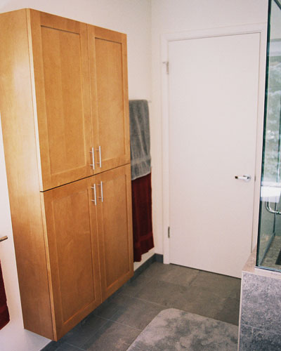 This new linen cabinet is innovative on several fronts.  First, the entire unit is recessed back into the framing, so it's actually 3 inch deeper than it looks.  It's also installed off the floor.  This floating installation helps keep the floor there a seamless line.