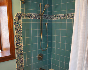 After seeing how great it looked at the vanity, the clients decided to repeat the pool at the tub/shower area.  The results are striking. Custom tile bathroom Seattle