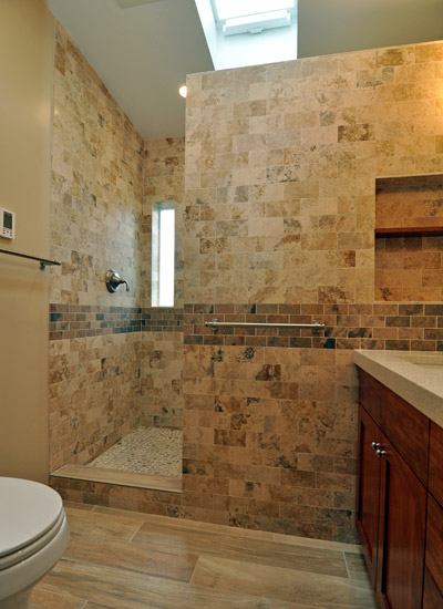 It's hard to know whether that vanity or the shower is the star here.  The shower benefits from a relocated and re-sized window, which provides a narrow, obscured-glass peek of natural light, while illuminated from above with a new solar-powered operable skylight.  It is full depth, using all the space that had been unused with the tub installation