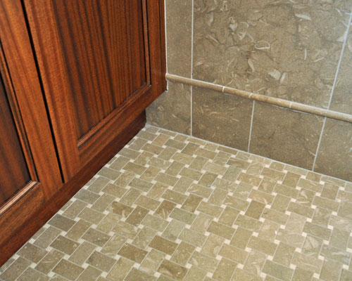 The cabinetry is set off visually from the subtle and beautiful tile work.  The tile is sea grass limestone, cut in a field pattern for the walls and a basket weave tile pattern for the floors, custom tile Seattle