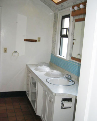 Before: funky skylight, laminate counters, terracotta tile.  One large bathroom with two doors and no privacy