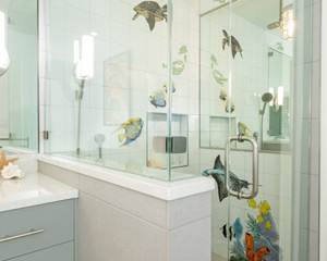 Shower with handpainted tiles in bathroom remodel
