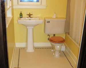 A minor bathroom remodel at the main floor is part of the project, with new hex tile and paint.  The vintage toilet remains in this bath remodel Seattle