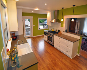 The finished spaces show all the problems solved. A new peninsula opens up the dining room to the kitchen, new wood flooring planes out with adjacent wood flooring, and the diagonal wall is gone from the mudroom.