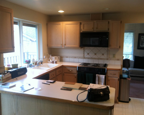 The previous kitchen was installed when the house was built in the early '90s.  Dated cabinets and a walled-in feeling was arbitrary and unnecessary.  The truss system allowed two walls to be removed with no additional structural work