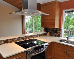 The island hood became a major feature of the kitchen.  The stove was previously on the opposite wall, and by moving it to a peninsula the stove becomes a focal point in the kitchen. Kitchen remodel Seattle