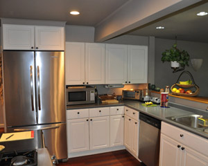 The existing cabinets were painted white and poorly executed, with odd spacing and no connection to the other architectural elements in the house.  Making matters worse, it was only a door opening away from beautifully detailed cabinets in anigre, part of an earlier fireplace remodel