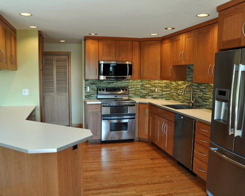 The new cherry cabinets with extra-wide shaker rails bring a deep wood glow to the remodeled kitchen.  They were selected with budget in mind but constructed with plywood boxes for longevity