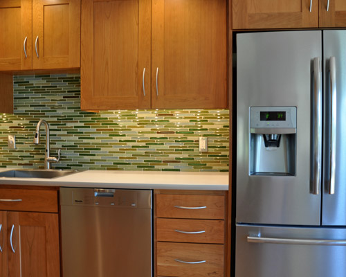 The new counters are laminate, but with an improvement over the old: a brushed aluminum vertical edge to match appliances and the sink and faucet