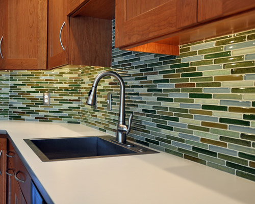 The backsplash tiles are handmade locally by Bedrock Industries and their color brings a nice counterpoint to all the wood