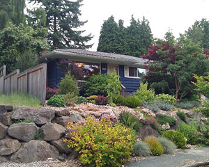 The home still had its original cedar shake siding, cupping and rotting under layers and layers of lead paint.  Old single pane aluminum windows were leaky, walls had no insulation and the roof was in need of replacing.  A comprehensive overhaul of the exterior was needed with lots of lead paint containment along the way