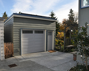 Front view of garage with access through door or garage door