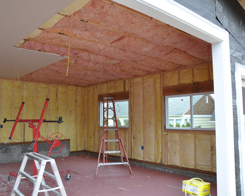 This garage includes space for both vehicles and a shop area, and was wired to accommodate large power tools.  The installation of insulation and sheetrock inside provides a finished shop space that is both comfortable and attractive